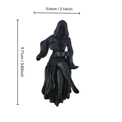 Black resin statue of a hooded figure holding a teacup, with dimension lines indicating a height of 9.71cm.