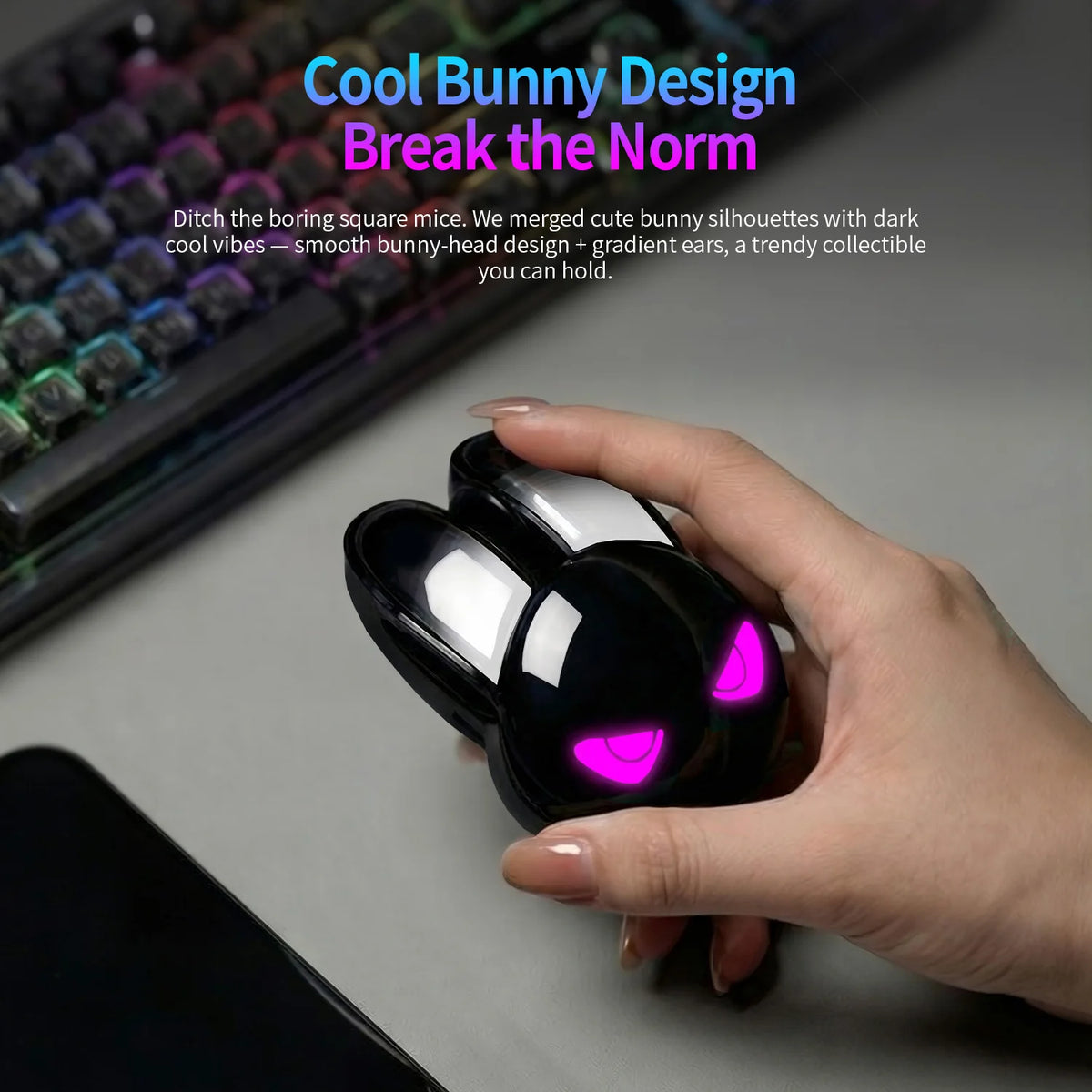 Hand holds a black rabbit-shaped wireless mouse with glowing pink eyes and long ears.