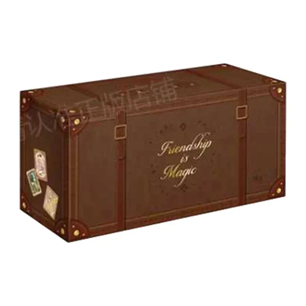 A brown trunk-style box with gold corner guards, straps, and buckles, reading "Friendship is Magic" on the side.