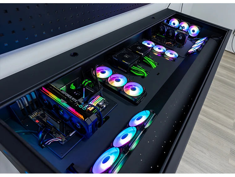 Black desk containing two built-in computer systems with illuminated RGB fans and components.