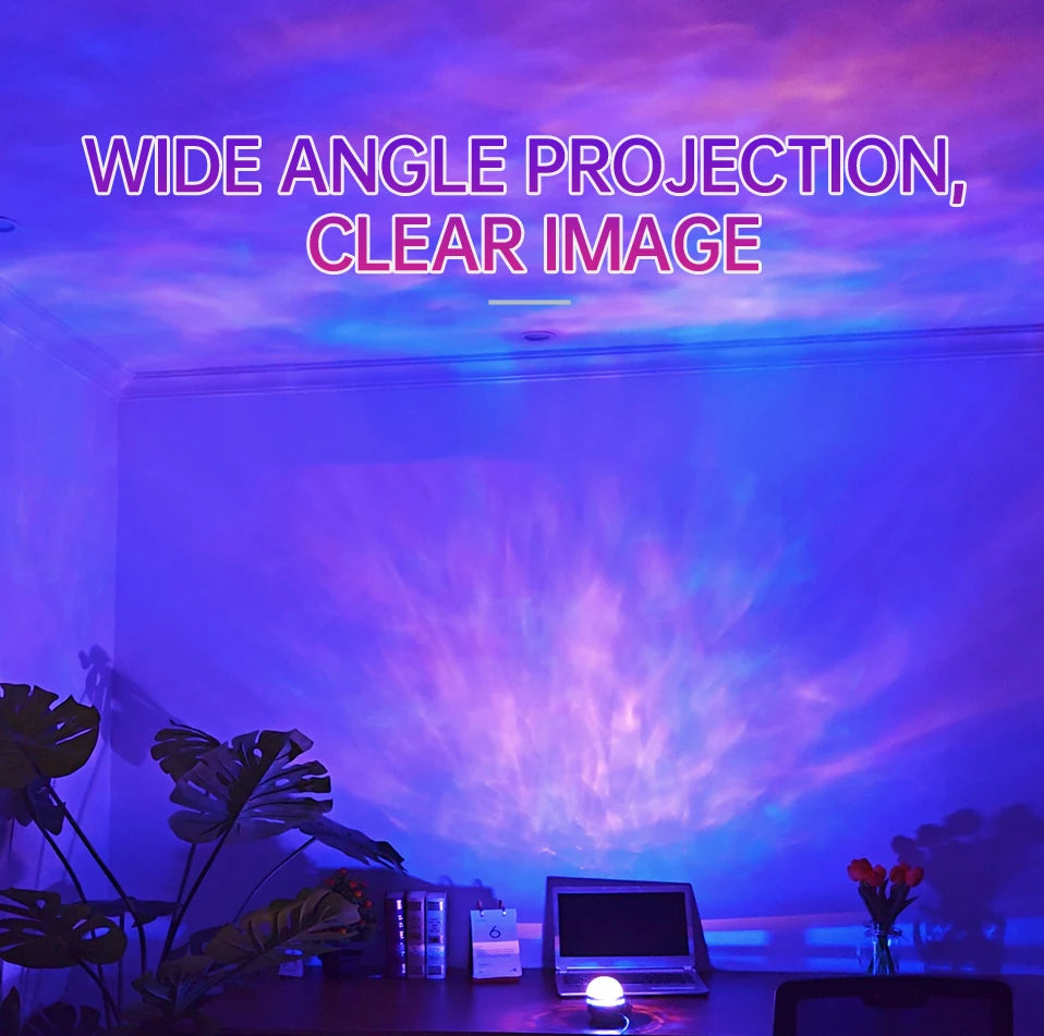 A round LED night light on a desk projects purple and blue light onto a wall and ceiling.