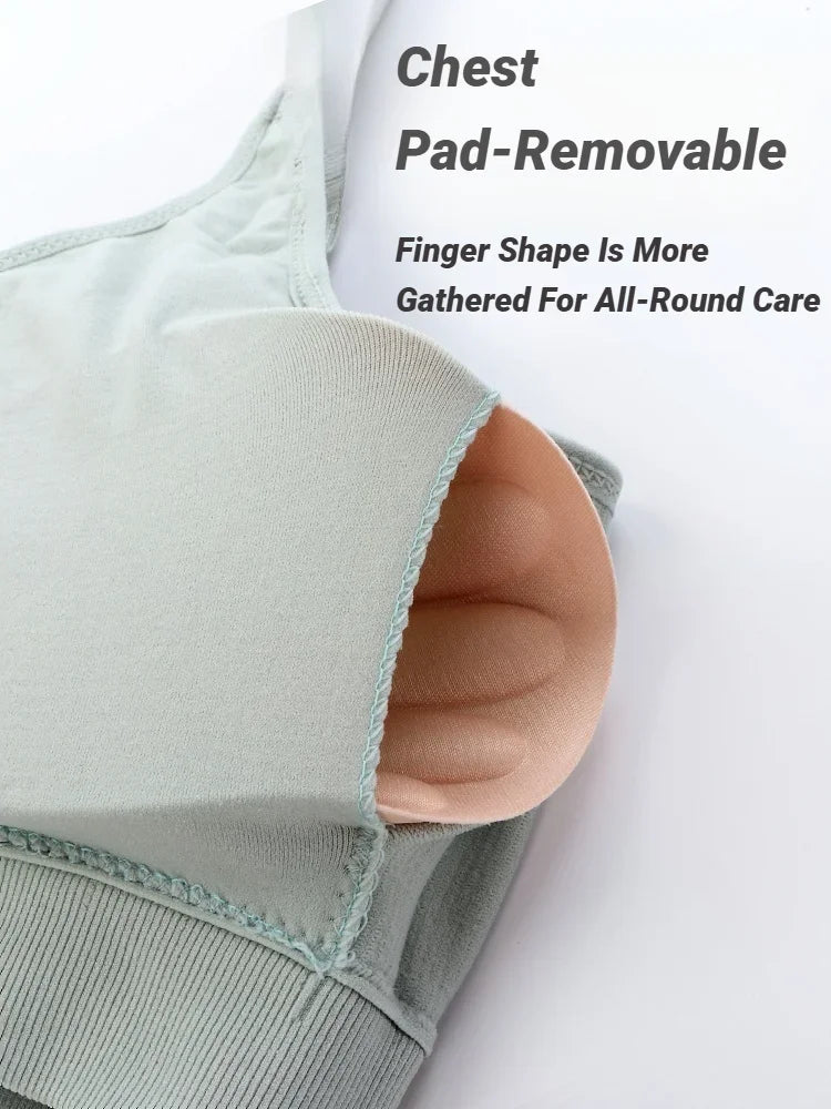 A light green seamless bralette with a removable beige finger-shaped chest pad extending from an inner pocket.