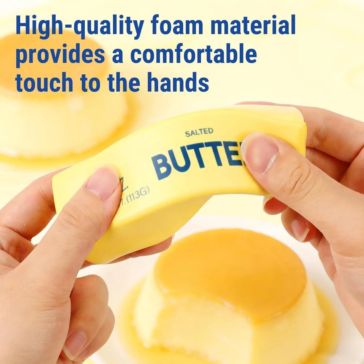 Hands squeeze a yellow butter-shaped stress toy labeled "BUTTER" and "SALTED".