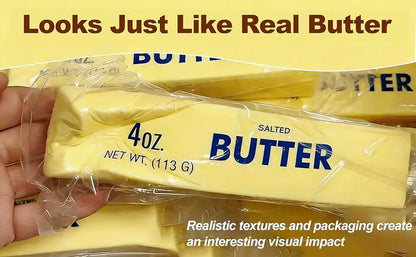 A hand holds a yellow stress toy styled as a 4oz stick of salted butter in clear plastic wrapping.