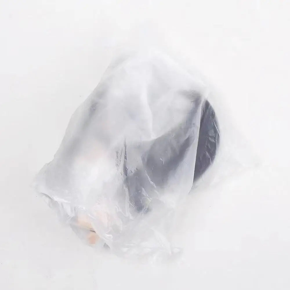 A dark-colored figurine or doll part sealed inside a translucent white plastic bag on a plain white background.