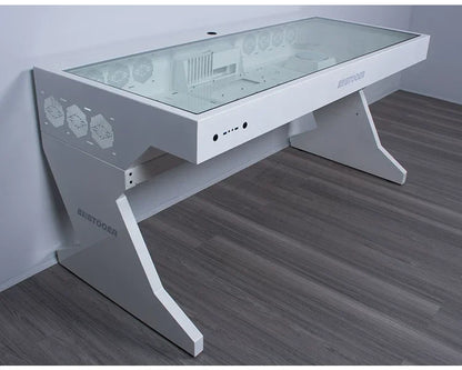 White desk with glass top enclosing PC components, angular legs, and integrated ports on the front edge.