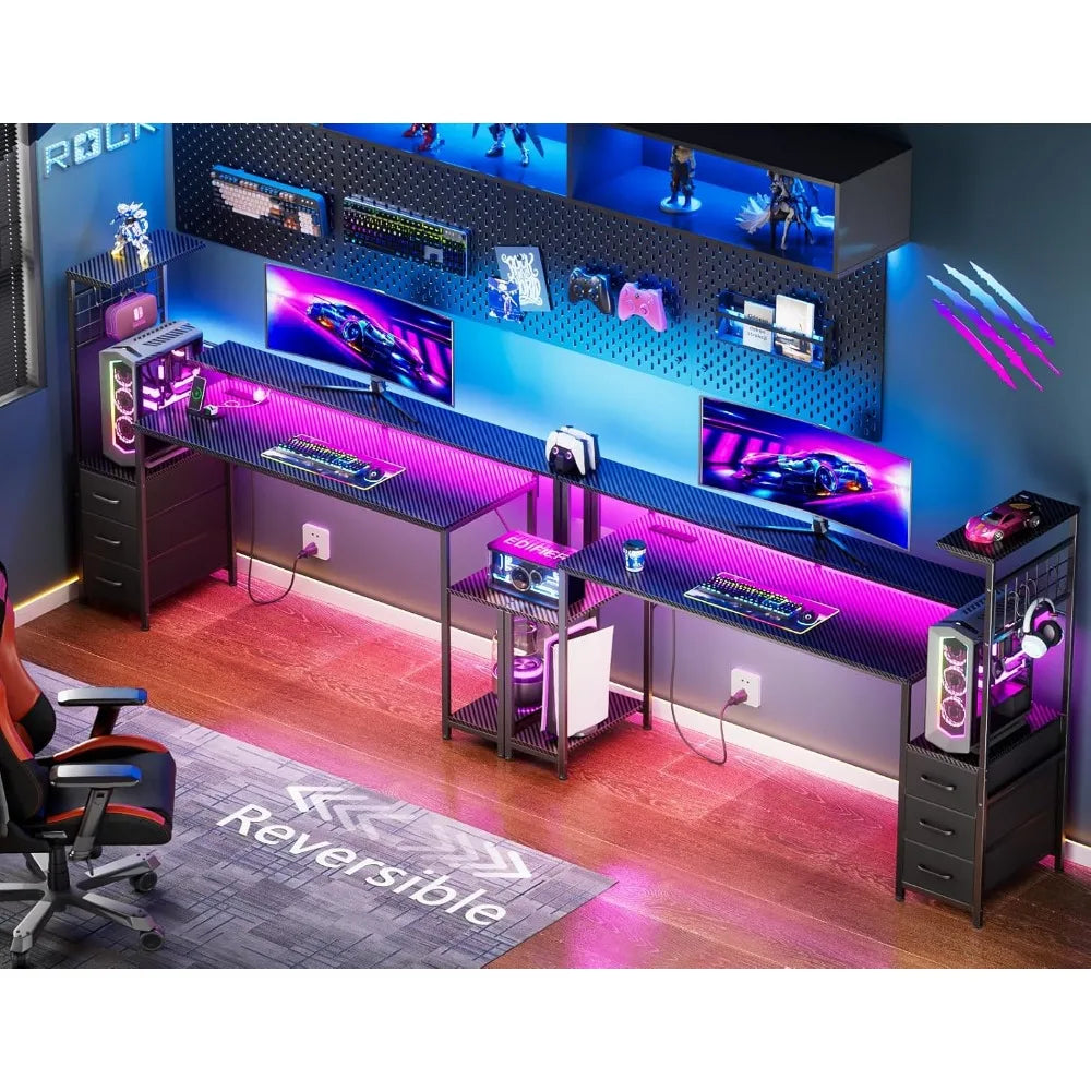 A black 63-inch reversible gaming desk featuring pink LED lights, shelves, drawers, and computer setups.