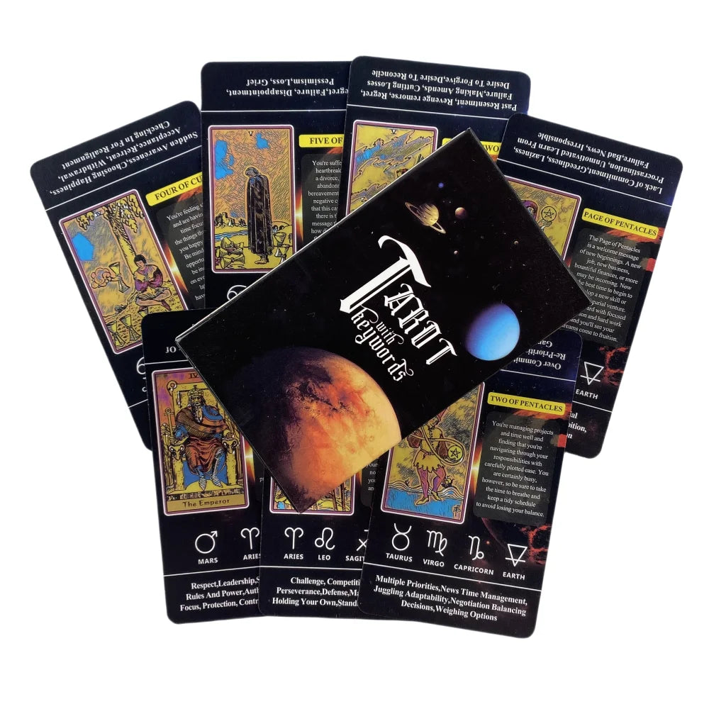 A black tarot deck box with a space theme sits atop a fan of colorful cards featuring astrological symbols and text.