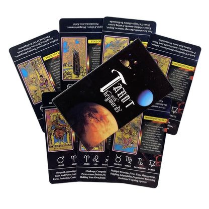 A black tarot deck box with a space theme sits atop a fan of colorful cards featuring astrological symbols and text.