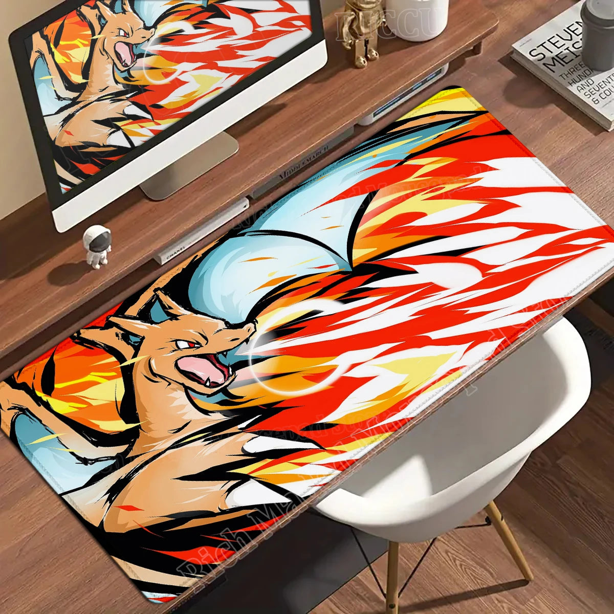 Charizard desk mat features an orange dragon breathing red, white, and yellow flames.