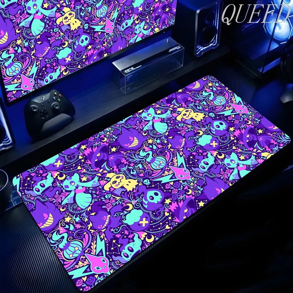 An XXL gaming mouse pad features a repeating Gengar pattern in purple, blue, yellow, and pink with skulls and stars.
