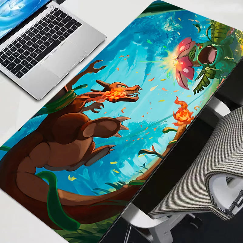Charizard and Venusaur battle on a large blue and green desk mat next to a laptop.