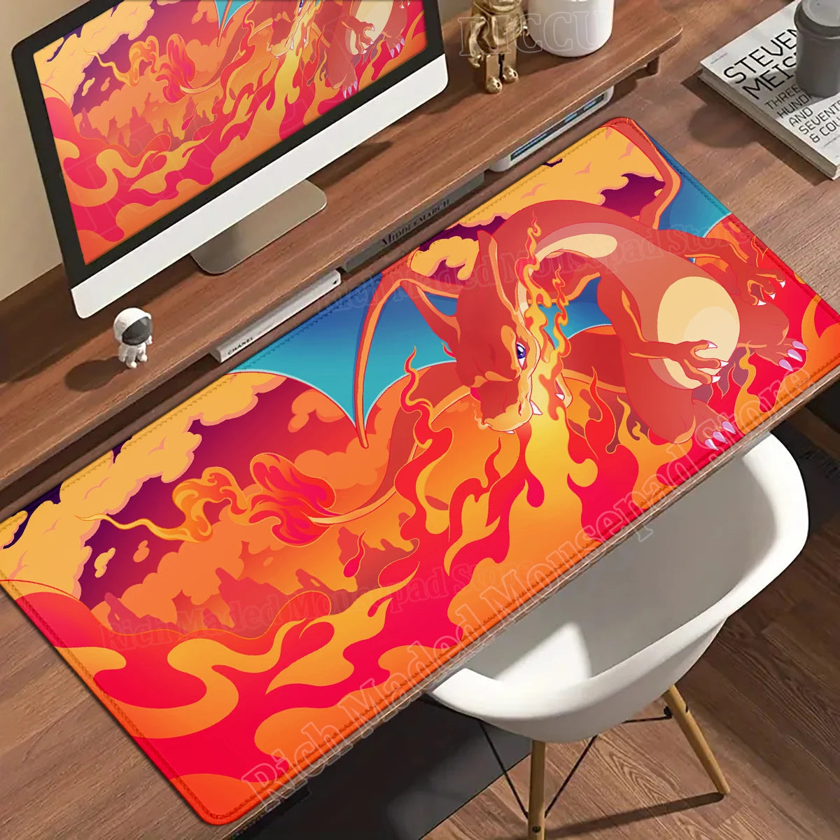 Large desk mat featuring Charizard breathing fire in red, orange, and blue against a stylized sky.