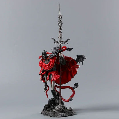 Detailed PVC figurine of a warrior in a flowing red cape holding a tall, ornate sword atop a rocky base.