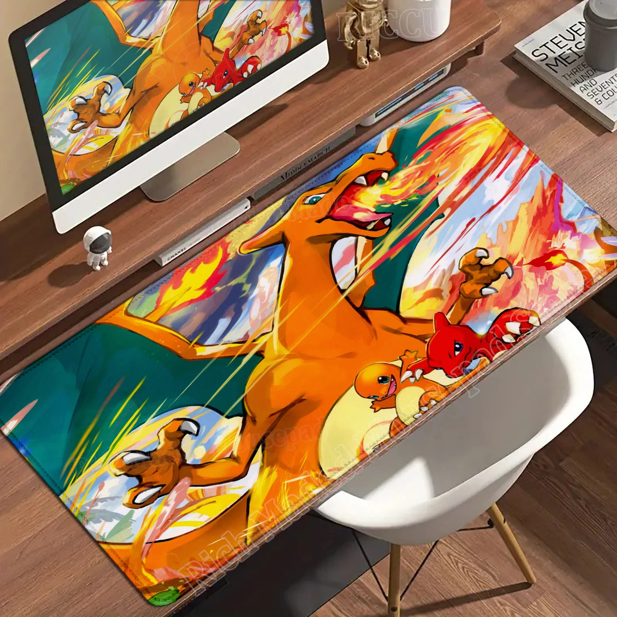 Charizard, Charmander, and Charmeleon breathing fire on a large colorful desk mat.