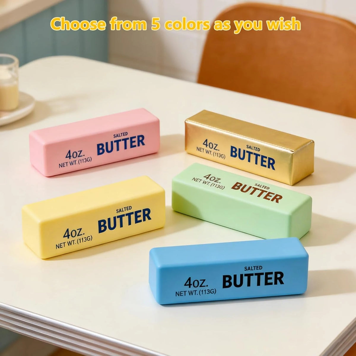 Five colorful stick butter stress toys in pink, gold, yellow, green, and blue, each labeled "4oz. Salted Butter".