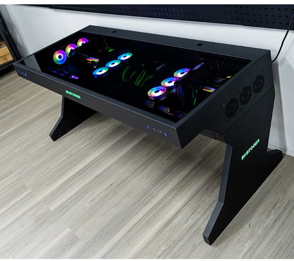 Black computer desk with a glass top housing two integrated PC builds featuring RGB fans.