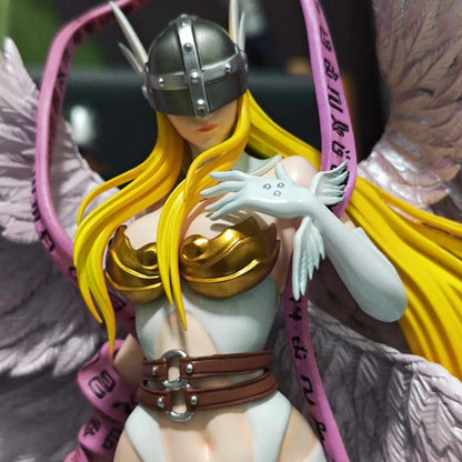 Angewomon PVC statue with blonde hair, a silver helmet, gold bra, white wings, and a pink ribbon.