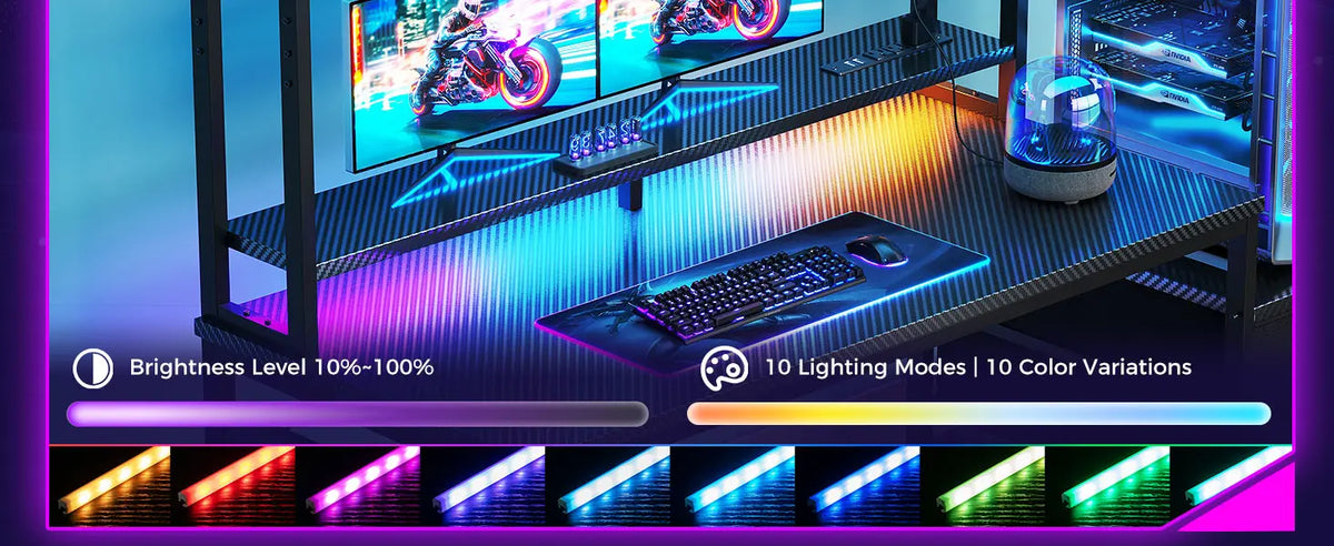 Black gaming desk with monitor hutch, keyboard, mouse, and multi-colored LED strip lighting controls below.