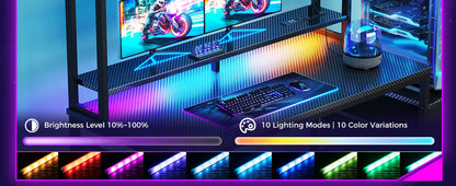 Black gaming desk with monitor hutch, keyboard, mouse, and multi-colored LED strip lighting controls below.