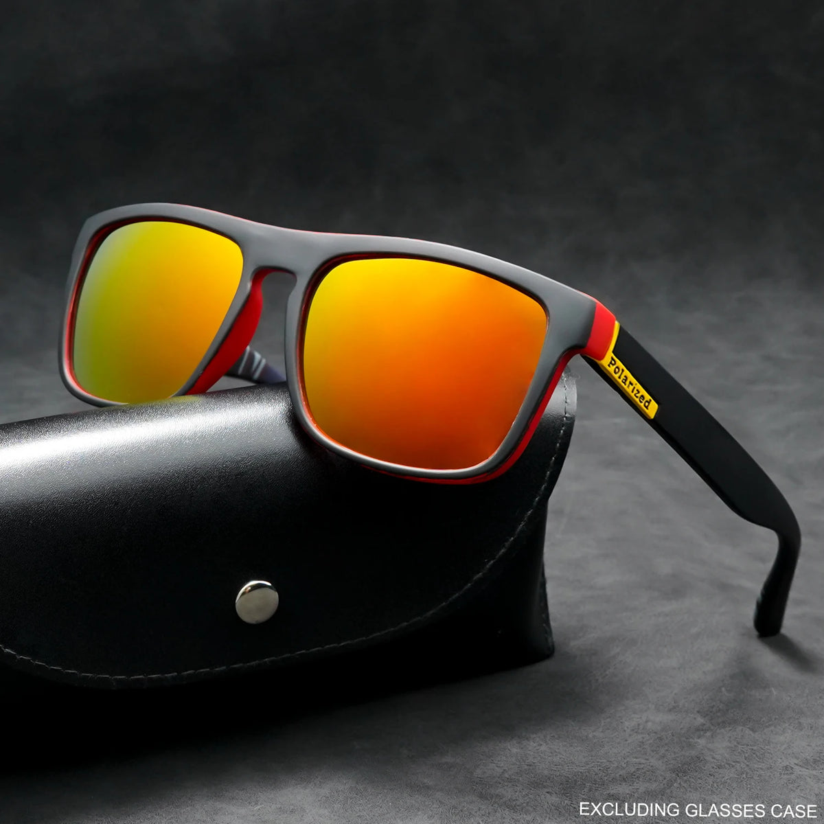 Black and red polarized square sunglasses with orange mirror lenses resting on a black case.