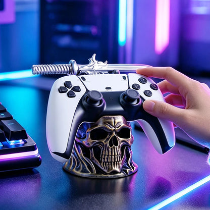A gold and black skull-shaped controller stand holding a white and black game controller, topped with a silver sword.