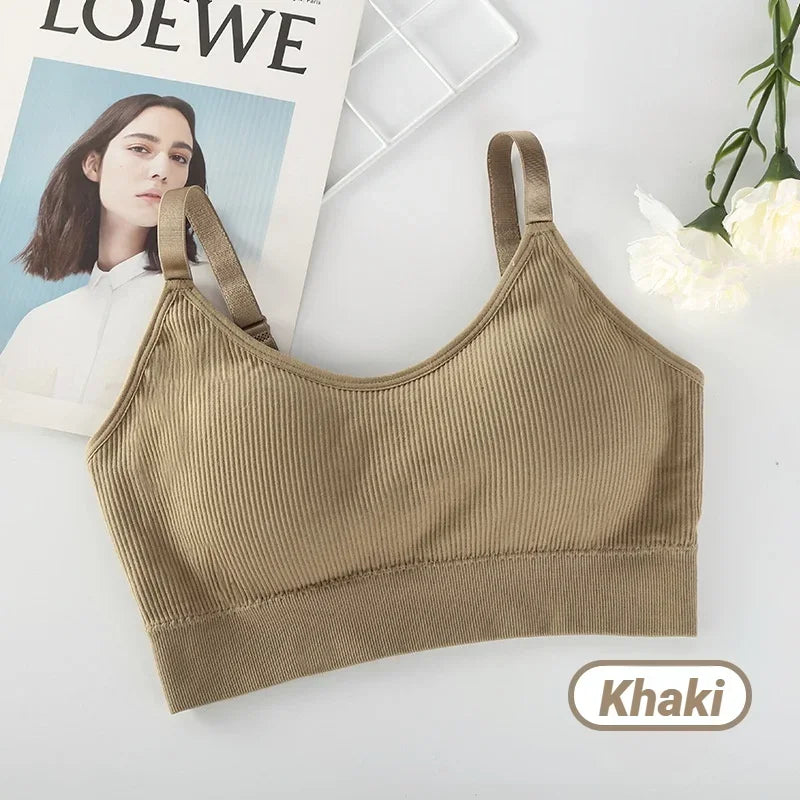 Khaki ribbed seamless bralette with wide straps, presented alongside a magazine page and white flowers.