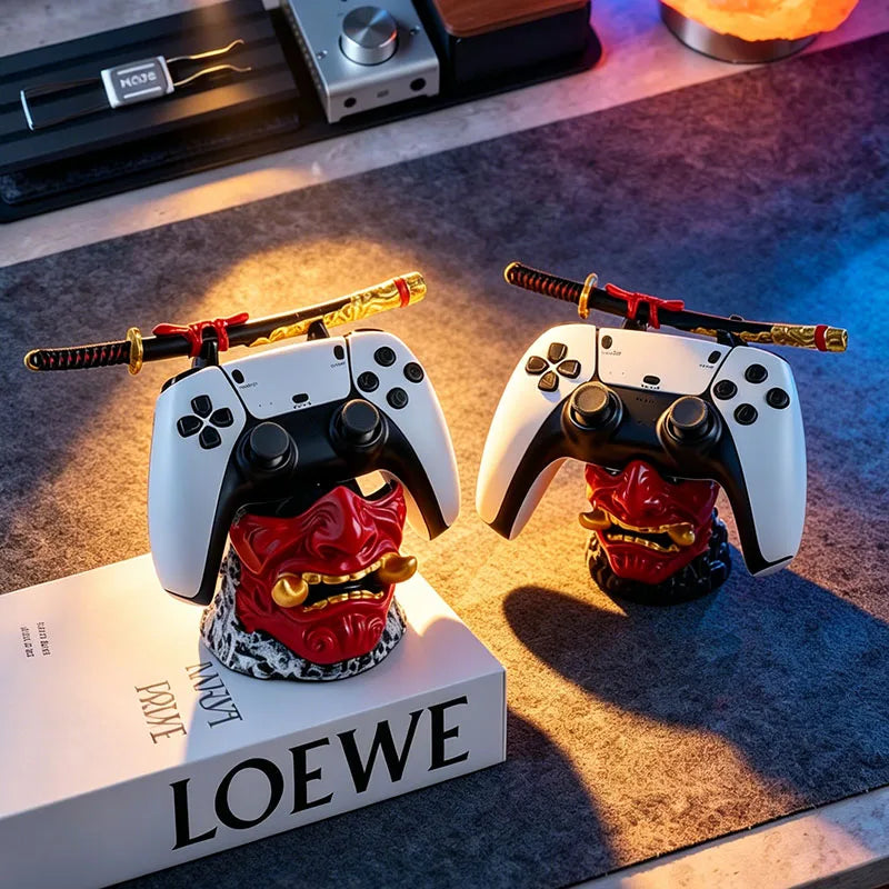Two red samurai oni mask stands hold white game controllers and miniature swords.