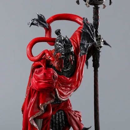 Detailed figurine in silver armor, flowing red robes, and black feathered wings, holding a tall staff.