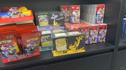 Simplified Chinese Pokémon TCG booster boxes and packs in red, black, and multicolored packaging on a shelf.