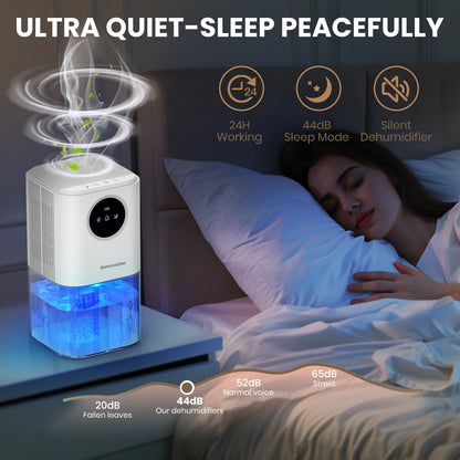 White portable dehumidifier with blue glowing water tank on a nightstand beside a sleeping person.