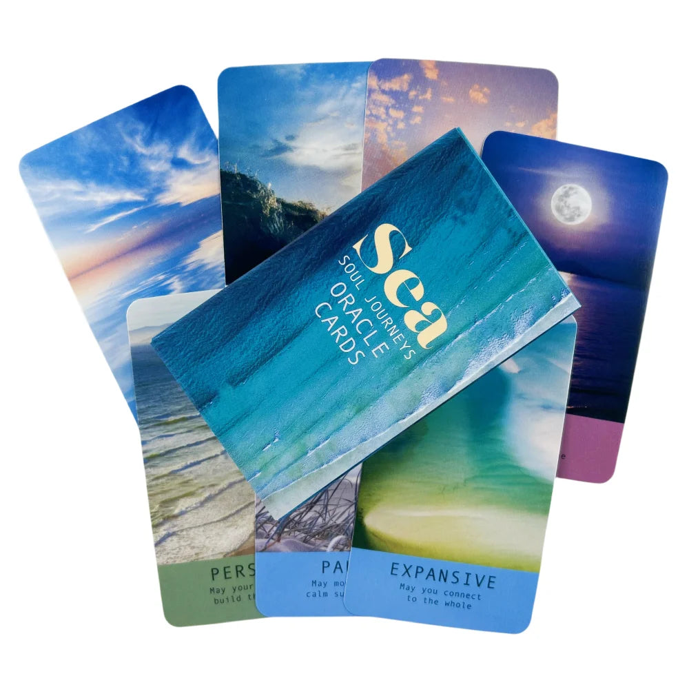 An open deck of "Sea Soul Journeys Oracle Cards" featuring blue ocean, sky, and moon scenes.