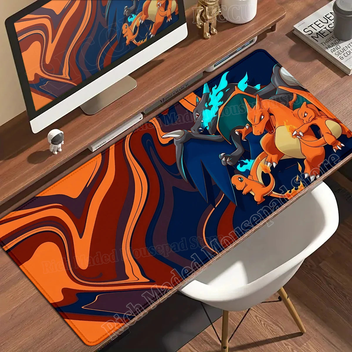 Orange and blue desk mat featuring Charizard evolutions on an abstract, swirling background.