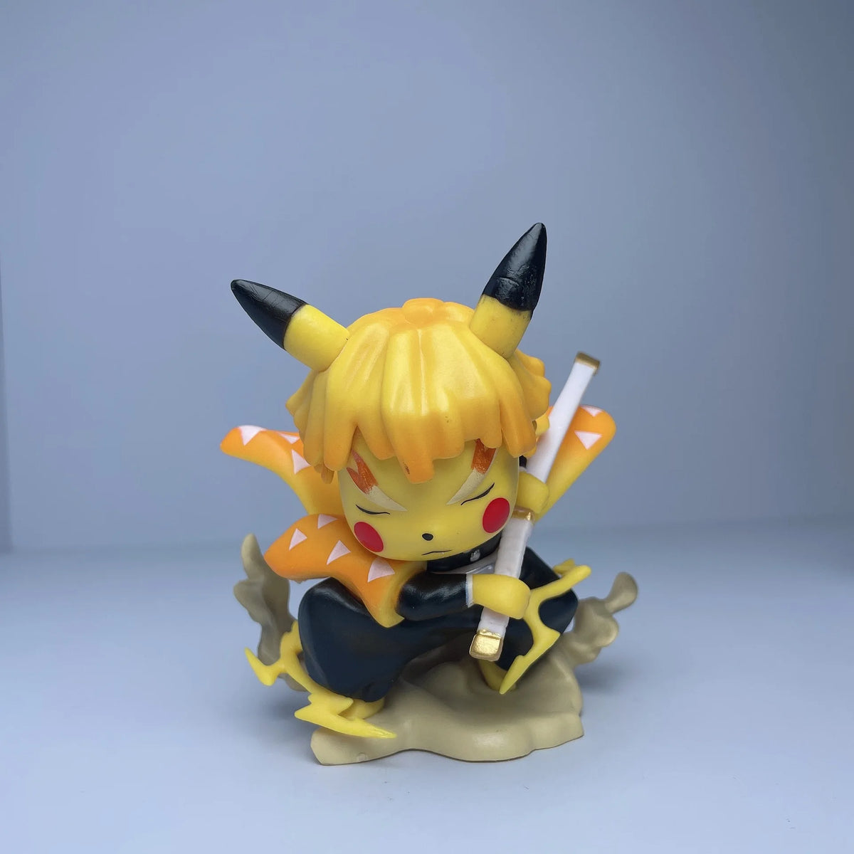 Yellow Pikachulike figurine with spiked blacktipped ears, yellow hair, patterned orange cape, and sword.