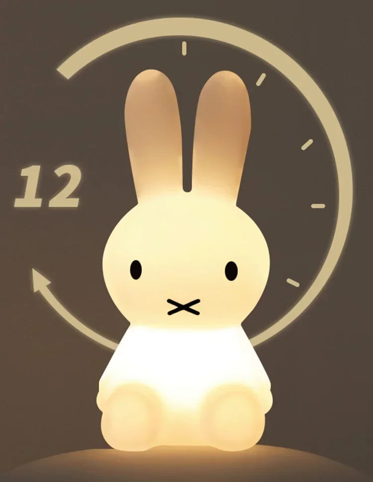Glowing Miffy night light shaped like a sitting rabbit with black dot eyes and an X mouth, set against a clock graphic with a 12.