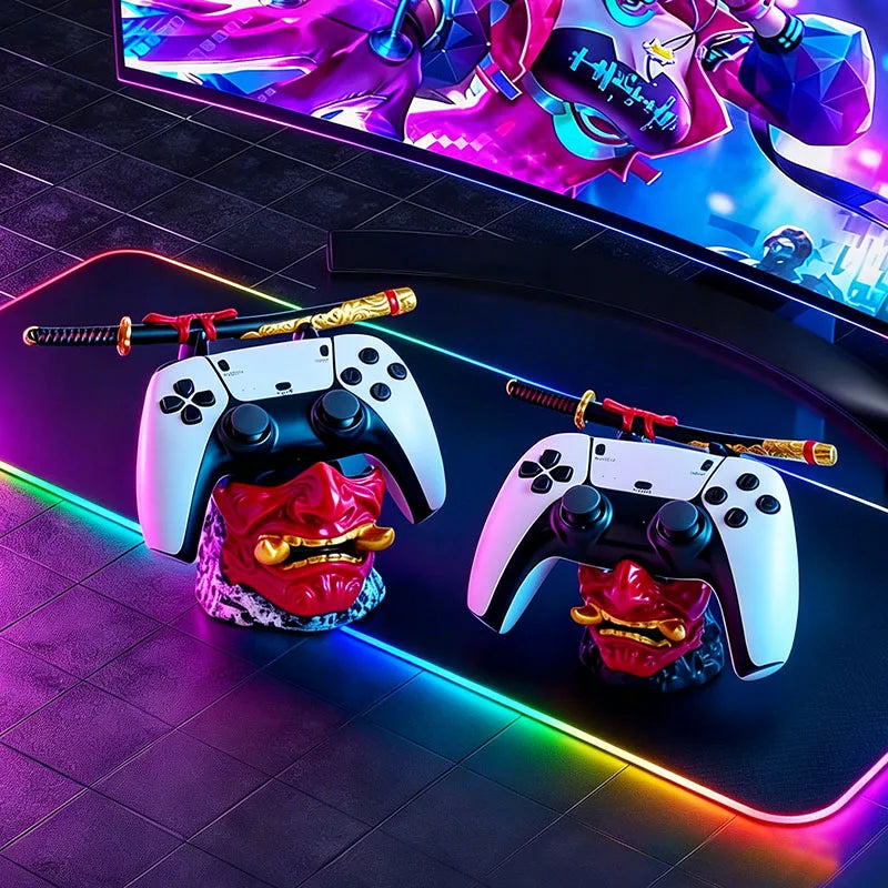 Two red oni mask controller holders with gold accents and miniature samurai swords, each holding a white and black controller.
