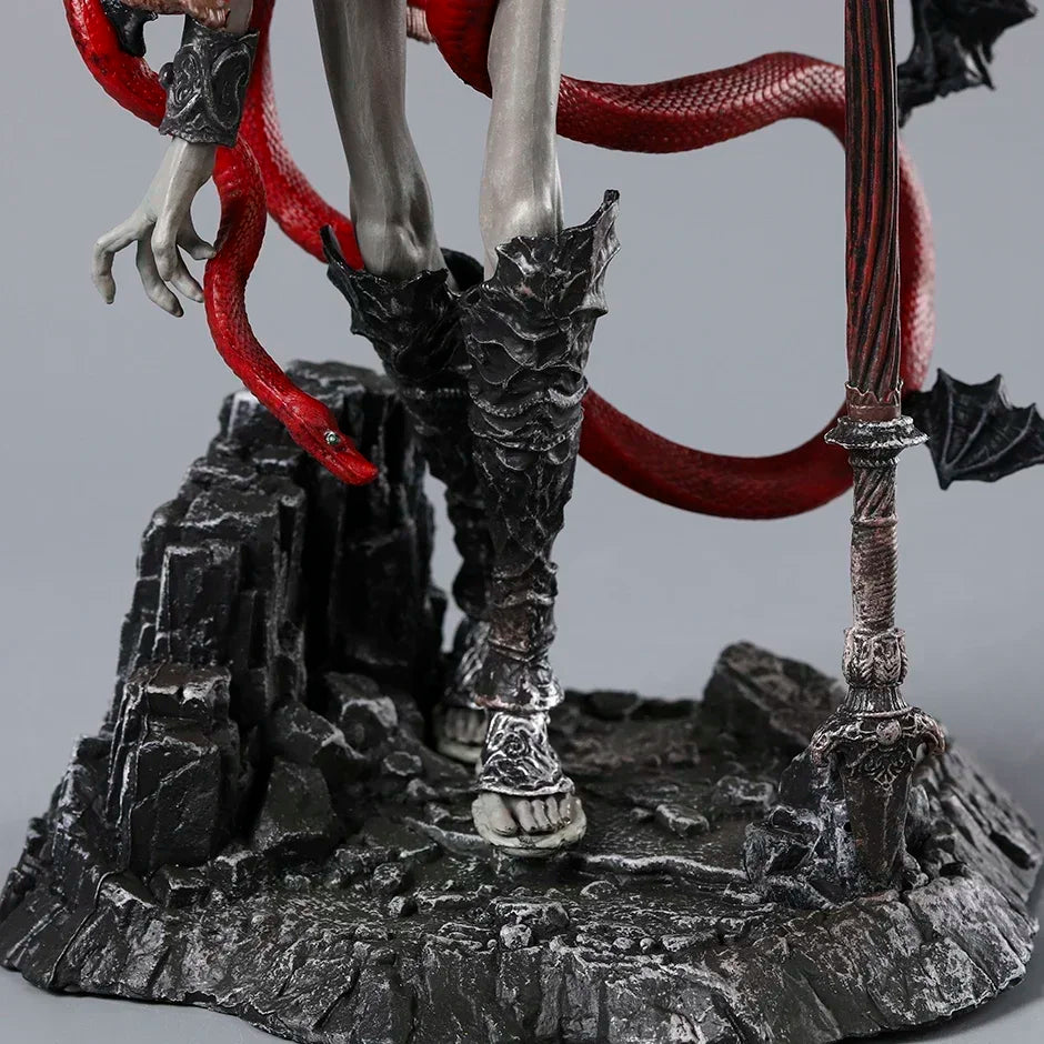 Grey-skinned figurine wearing ornate black greaves and sandals on a rocky base, wrapped by a red snake and holding a staff.
