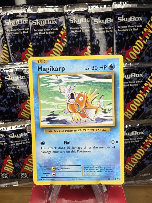 Magikarp Pokémon card featuring an orange fish surrounded by blue water, with yellow and white borders.
