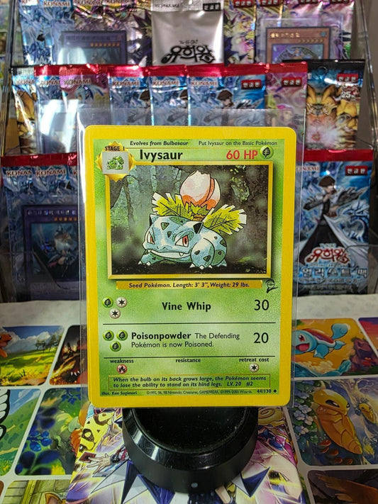 Ivysaur 60 HP trading card in a protective sleeve against a background of card packs.