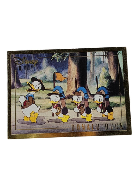 A Disney trading card featuring Donald Duck and his three nephews hiking in the woods.