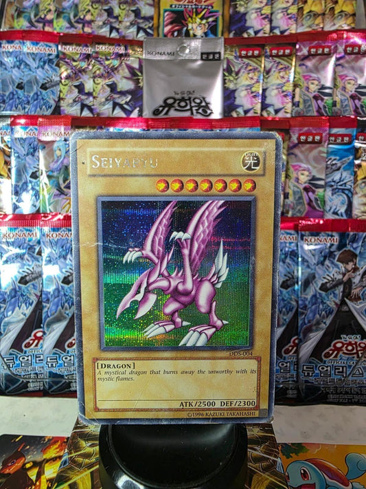 Seiyaryu Yu-Gi-Oh! trading card against a background of foil booster packs.