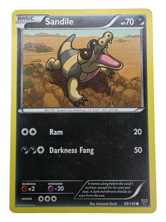 Sandile 69/146 common Pokémon card from the XY Base Set featuring artwork of the reptile on rocks.