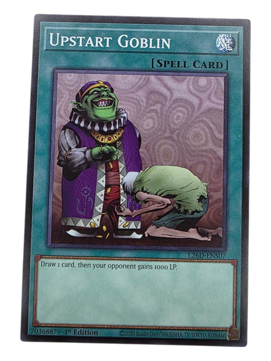 Upstart Goblin Yu-Gi-Oh! Spell card featuring artwork of a green goblin dropping coins to a kneeling figure.
