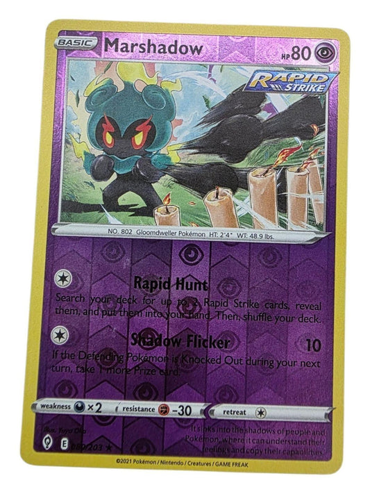 Marshadow Holo Rare Pokémon card from Evolving Skies featuring glowing candles and purple foil.