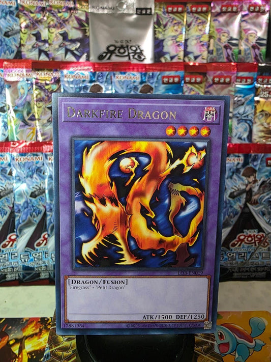 Darkfire Dragon Yu-Gi-Oh! card displayed against a background of booster packs.