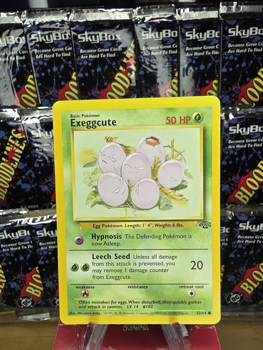 Vintage green Exeggcute Pokémon card with 50 HP, featuring illustration of six egg-like characters in a nest.